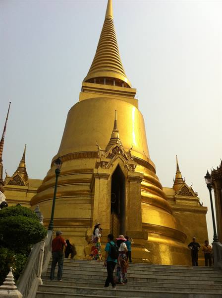 Tourists climb the stairs of the golden stupa at Wat Phra Kaew, Bangkok