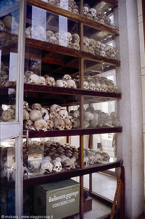 Victims' skulls displayed behind glass at Choeung Ek memorial stupa