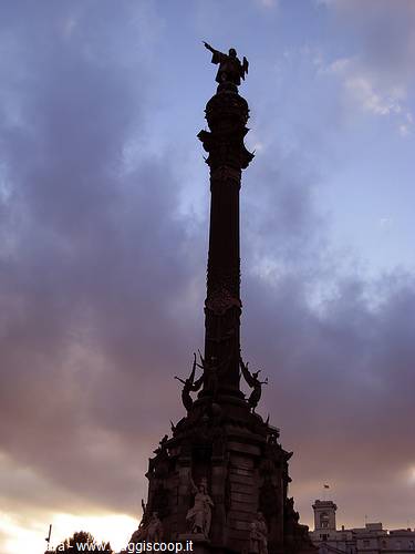 Columbus Monument in Barcelona silhouetted against dusk sky, statue atop column
