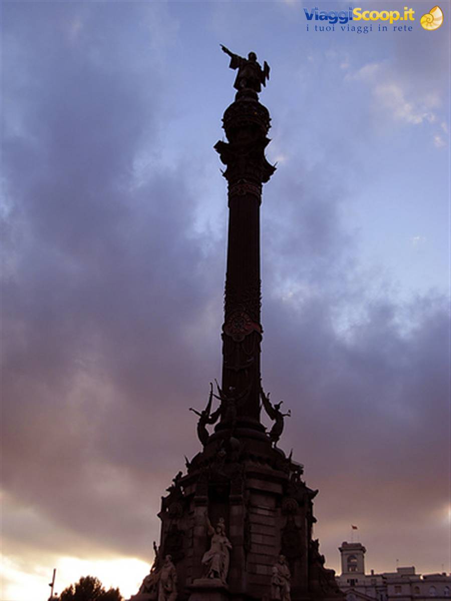 Columbus Monument in Barcelona silhouetted against dusk sky, statue atop column