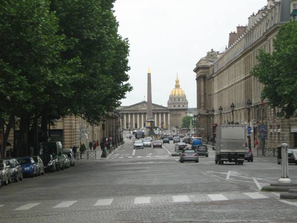 Rue Royale toward Place de la Concorde, obelisk and Invalides dome under grey sky