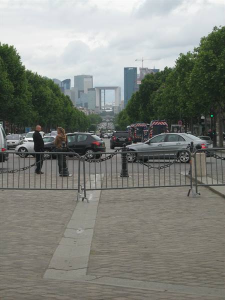 Grande Arche de la Défense seen from Champs-Élysées, with metal barriers and traffic