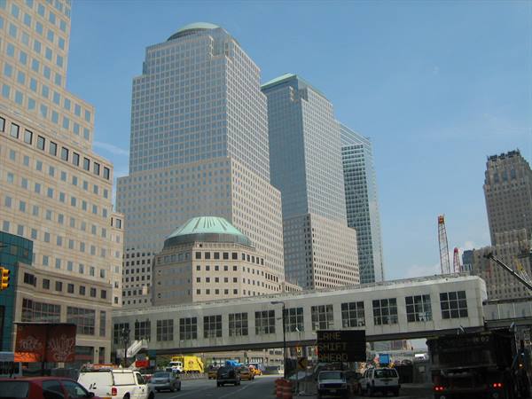 World Financial Center towers above a busy street with vehicles and a temporary walkway