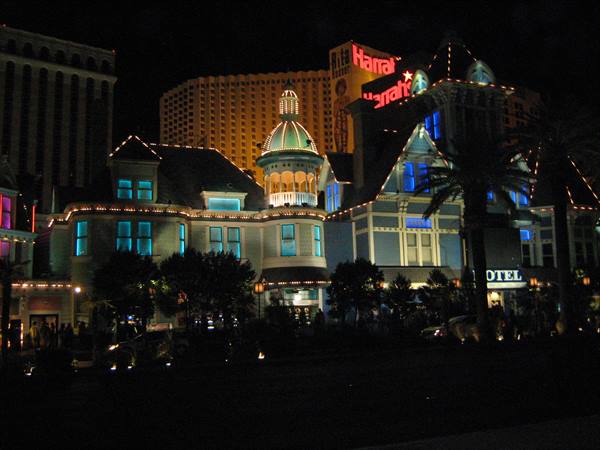 Harrah's casino lit up at night on the Las Vegas Strip with neon signs