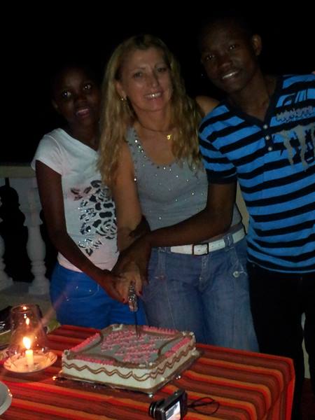 CUTTING THE CAKE WITH THOMAS'S ORPHANED GRANDCHILDREN