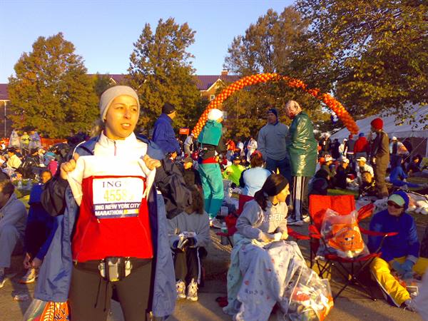 Runner shows ING New York City Marathon bib among crowd in the park