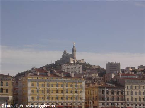 Notre-Dame de la Garde above rooftops and buildings of Marseille's old port