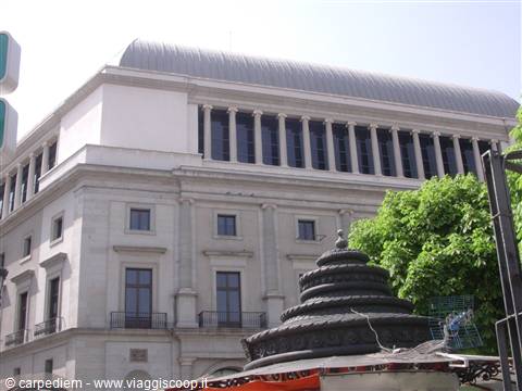 Madrid's Teatro Real in morning light, with an iron fountain in the foreground