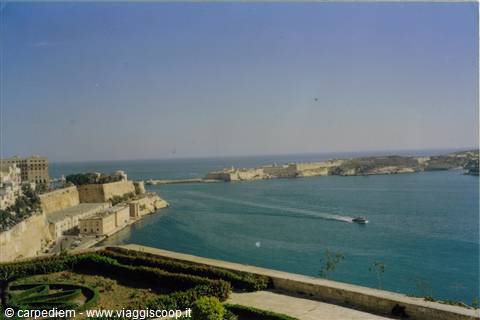 Valletta's Grand Harbour, limestone bastions and a ferry crossing the blue water