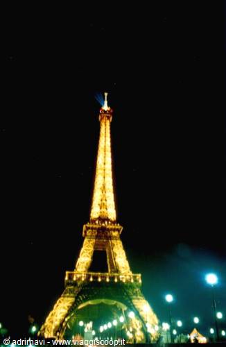 The Eiffel Tower lit up at night in Paris, golden lights in darkness