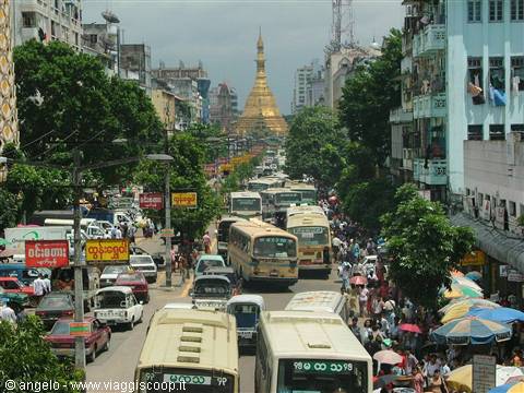 Buses and crowds on a busy street leading to the golden Sule Pagoda, Yangon