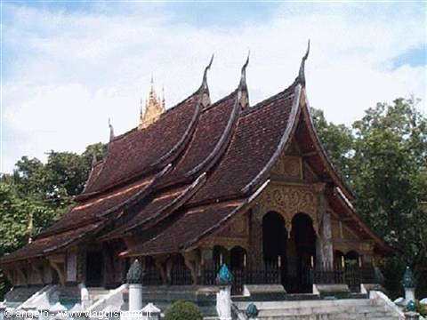 Wat Xieng Thong in Luang Prabang: sweeping dark tile roofs under a cloudy sky