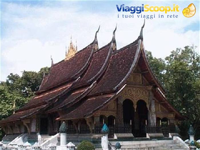 Wat Xieng Thong in Luang Prabang: sweeping dark tile roofs under a cloudy sky