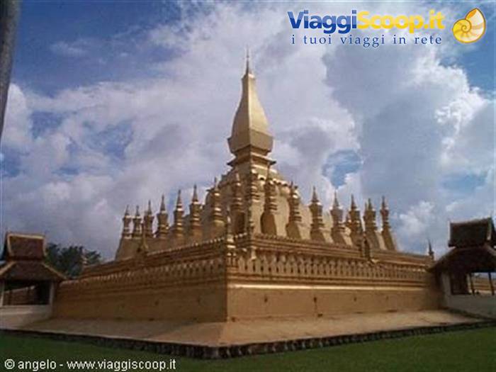 Pha That Luang golden stupa in Vientiane, under white clouds and blue sky