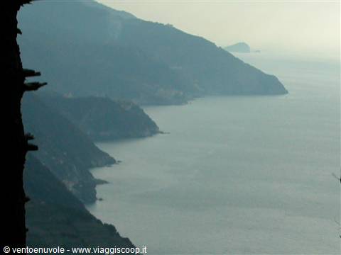 Rocky coastline shrouded in haze over the sea, Cinque Terre