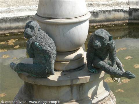 Bronze monkey statues around a marble fountain