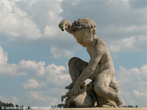 Stone statue of a boy wrestling a goose under cloudy sky