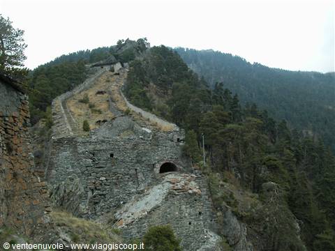 Ruined stone walls climbing the forested mountain, Fenestrelle Fort