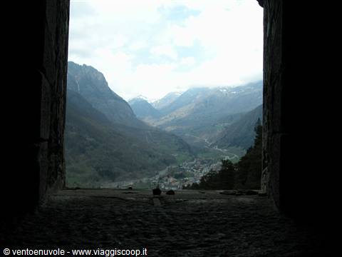 Valley and village framed by the stone opening of an old fortress