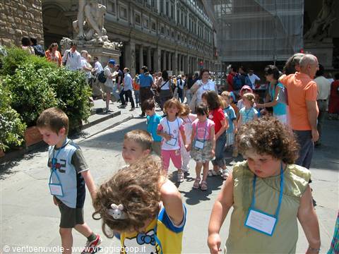 Schoolchildren walking past the Loggia dei Lanzi statues in Florence