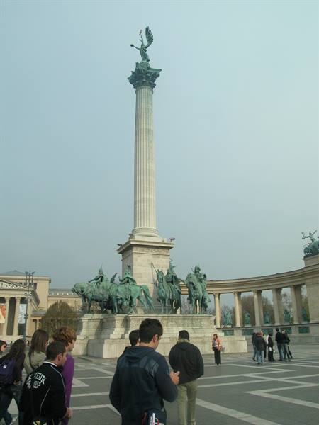 Tourists in front of the Millennium Column with horse statues in Budapest
