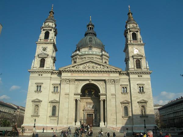 Tourists on the steps of St. Stephen's Basilica in Budapest, dome and bell towers