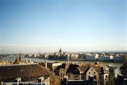 Budapest: rooftops and Danube river toward the Parliament under blue sky