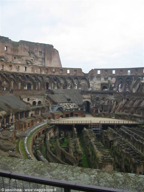 Inside Rome's Colosseum, brick hypogeum corridors under a grey sky