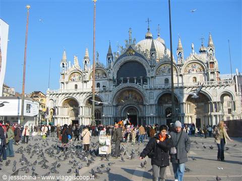 Tourists and pigeons in St Mark's Square in front of the Basilica, Venice