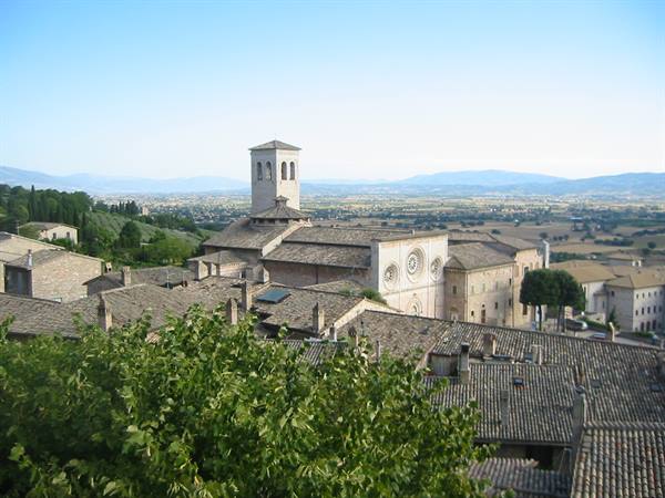 Basilica of San Francesco in Assisi above stone rooftops