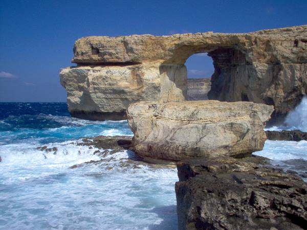 Natural limestone arch over the sea, waves crashing on rocks, Azure Window, Gozo