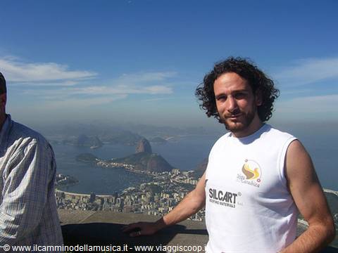 Tourist on Corcovado, Guanabara Bay and Sugarloaf Mountain behind
