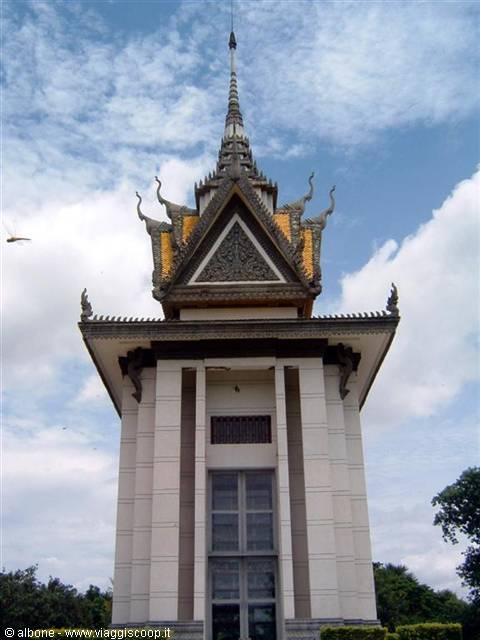 White Killing Fields stupa in Phnom Penh, golden carved spire under clouds