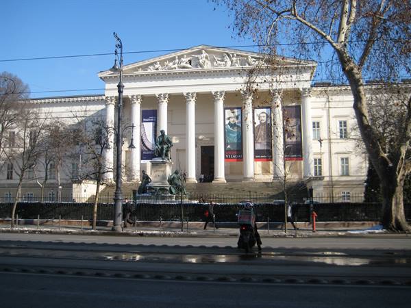 Hungarian National Museum in Budapest, neoclassical columned facade with a motorbike passing by