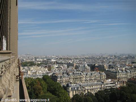From the Eiffel Tower terrace, Paris rooftops and domes under a blue sky
