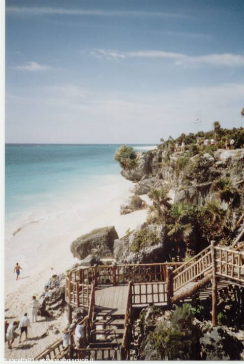 Wooden staircase on the cliff above the white beach at Tulum