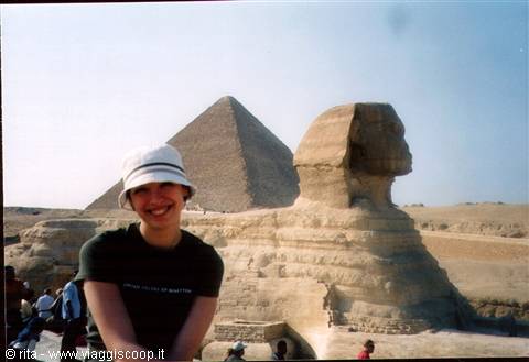 Smiling tourist in front of the Sphinx and Giza pyramid