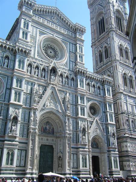 Marble facade of Florence Cathedral with Giotto's bell tower under sun