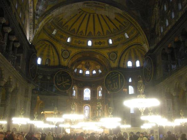 Inside Hagia Sophia in Istanbul: golden dome, Islamic medallions, glowing chandeliers