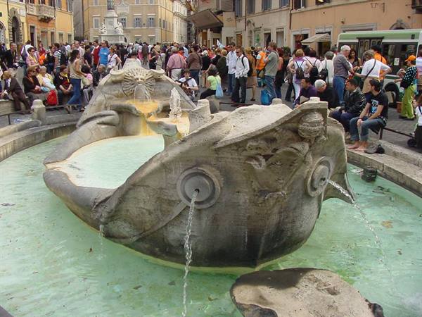 Crowds around the Barcaccia fountain by Bernini at Piazza di Spagna, Rome