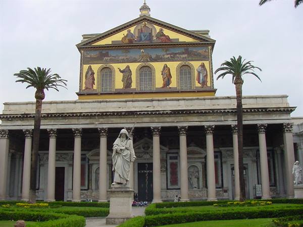 Saint Paul statue before the basilica with golden mosaics and palm trees