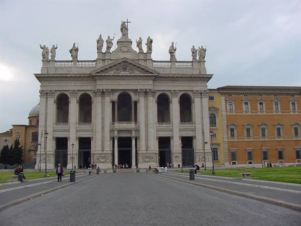 Facade of St. John Lateran in Rome with saint statues and passersby