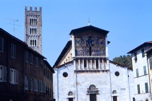 Marble facade of San Frediano basilica with mosaic and bell tower, Lucca