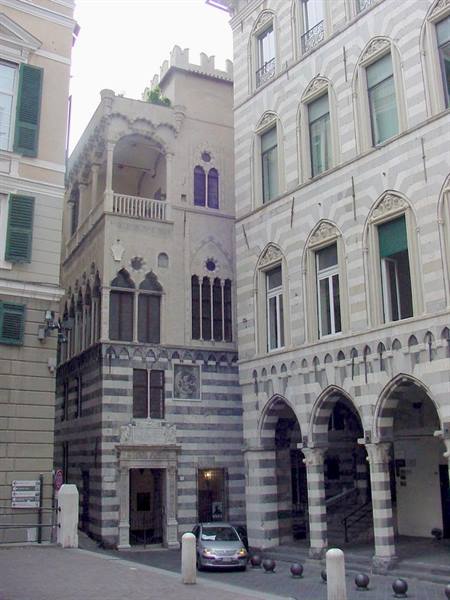 Genoa, medieval bicolour stone palace beside arched colonnades