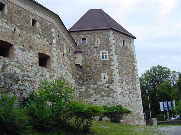 Stone pentagonal tower of Ljubljana Castle under cloudy sky