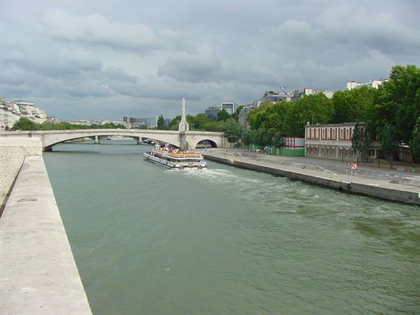 Tour boat on the Seine under the bridge, Paris