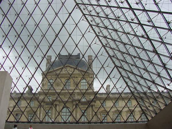 The Louvre seen through the steel and glass lattice of the pyramid