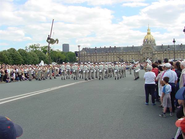 Military parade in front of Les Invalides, Paris, crowd watching along the avenue