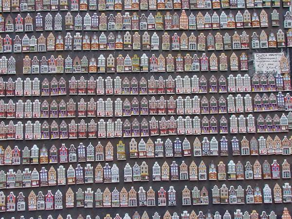 Amsterdam canal house magnets arranged in rows on a market stall