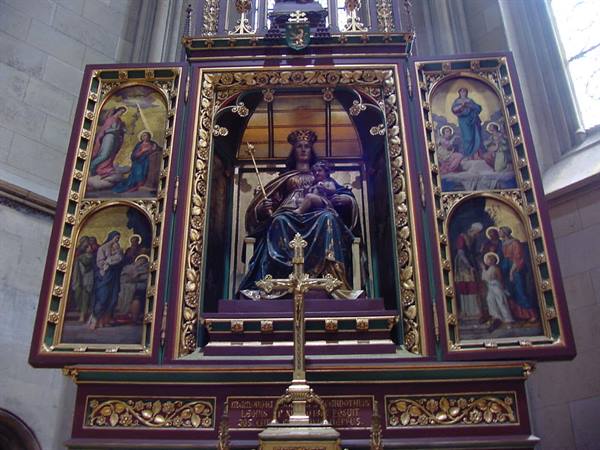 Gilded triptych altar with Madonna and Child statue inside Cologne's Gothic cathedral